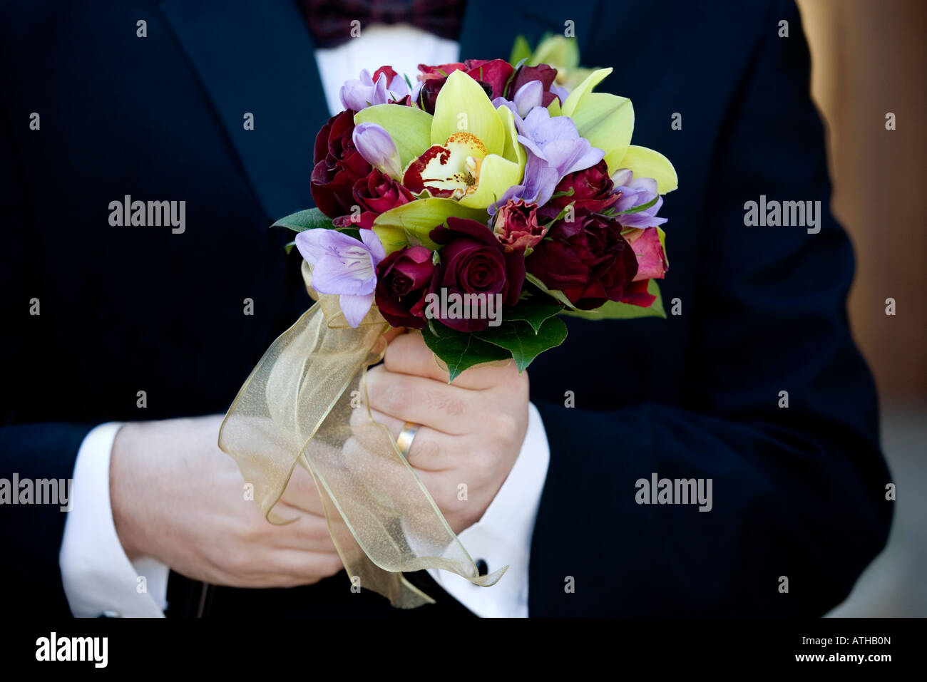 Groom holding flowers Stock Photo