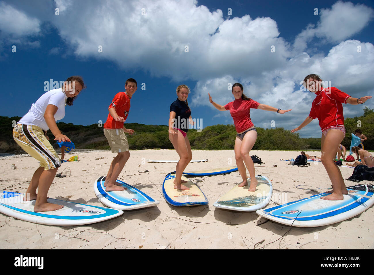 surf lesson school, caribbean, people on the beach, surf, teenagers, water sport, funny, summer, holiday, vacation, adventure Stock Photo