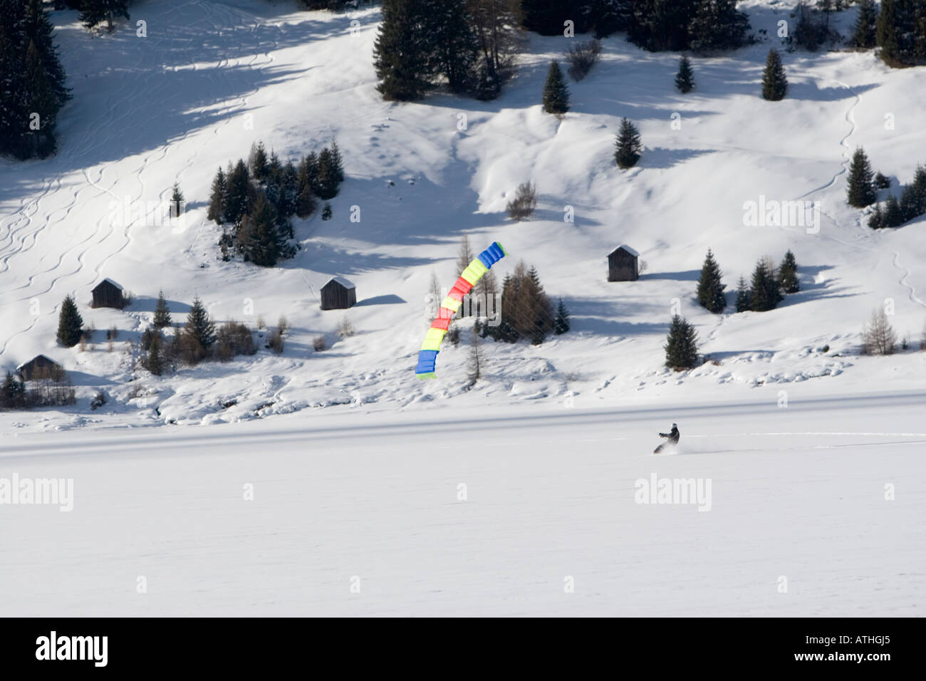 snowboarding with parachute on the frozen man-made lake of Resia, Italy  Stock Photo - Alamy