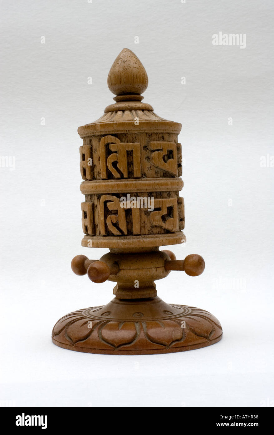 Handheld Nepali wooden carved prayer wheel or wheel of life Stock Photo