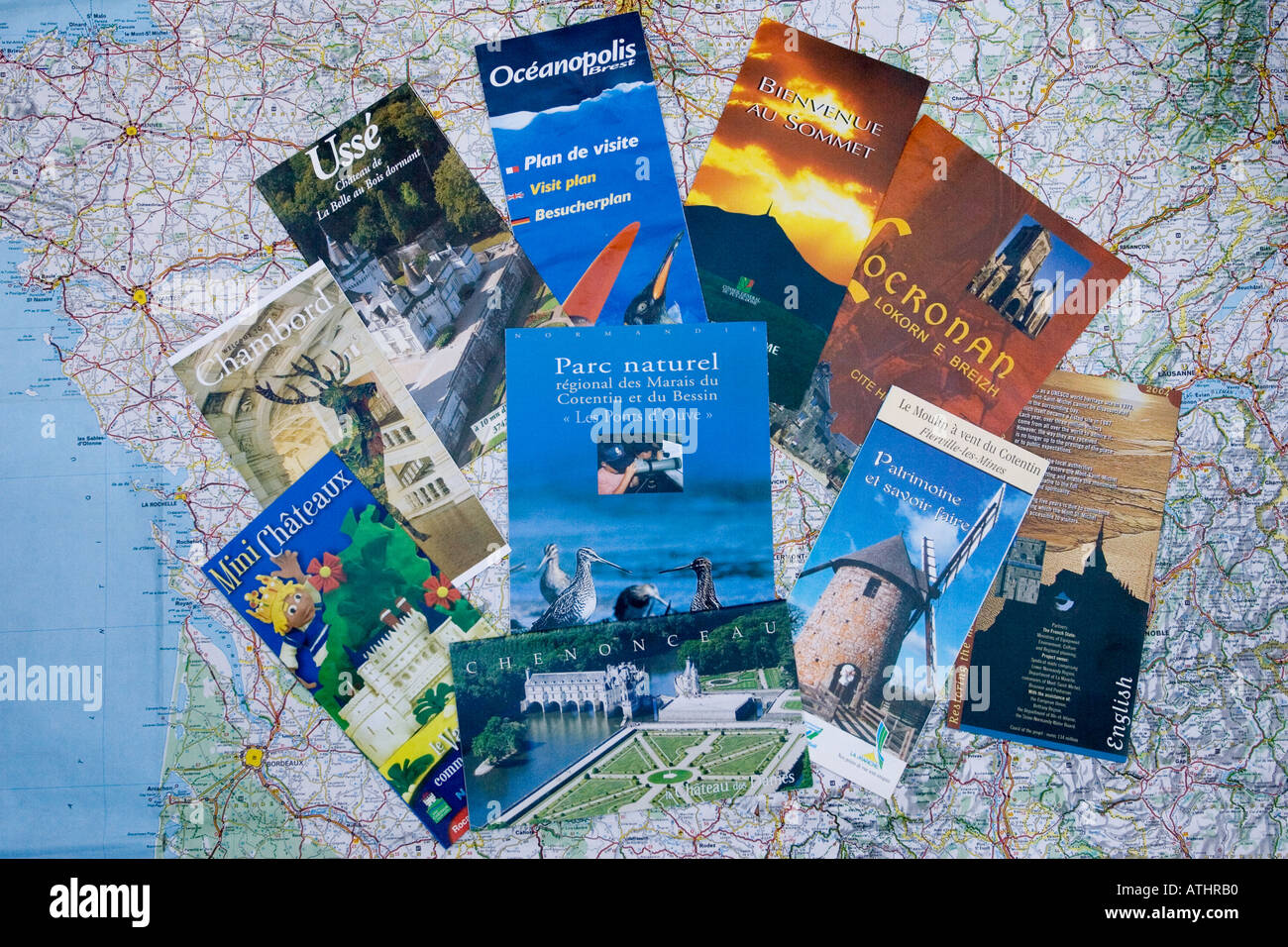 French tourist brochures scattered on map of France Stock Photo