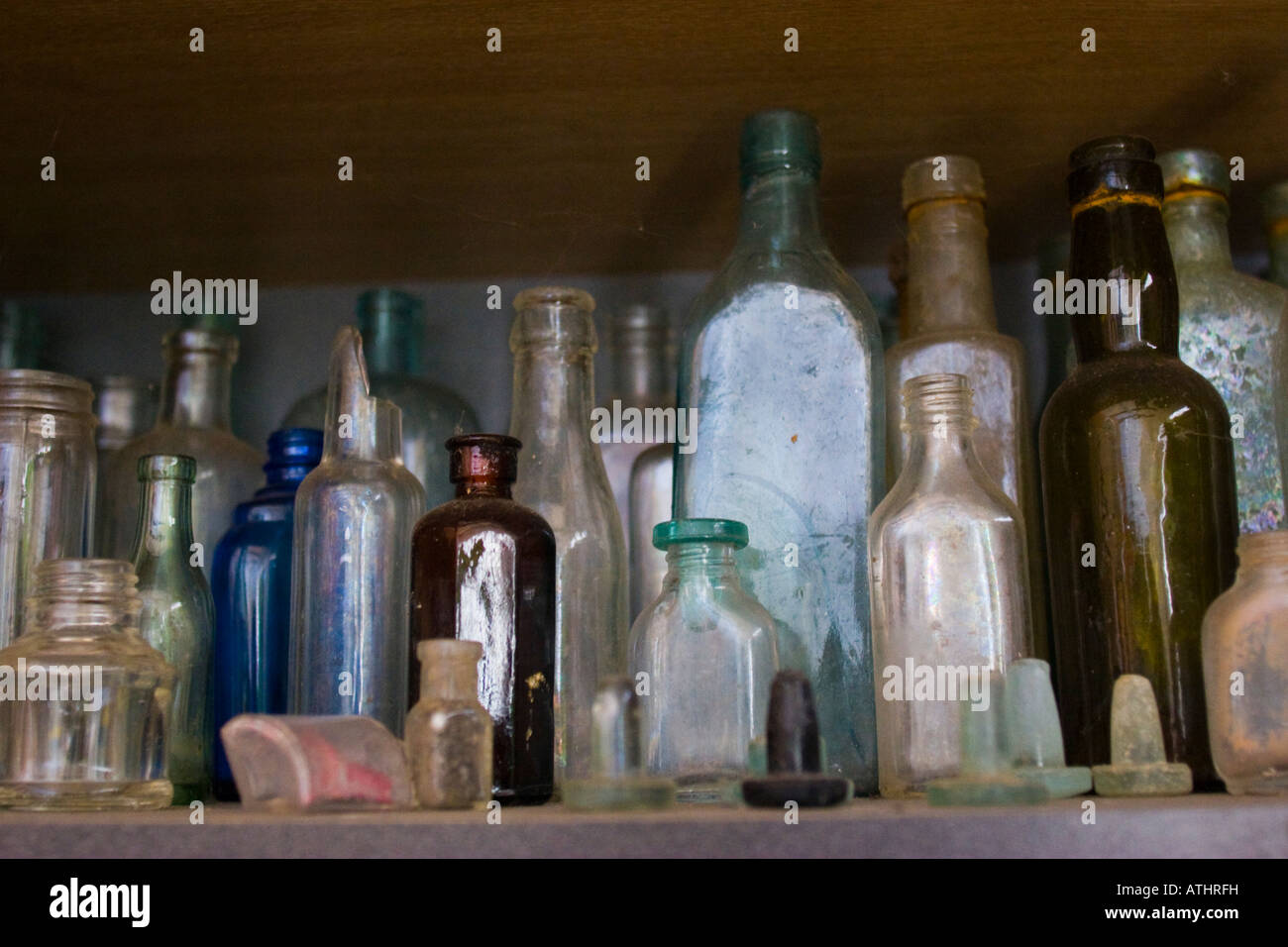 Vintage glass bottles and stoppers on shelf Stock Photo