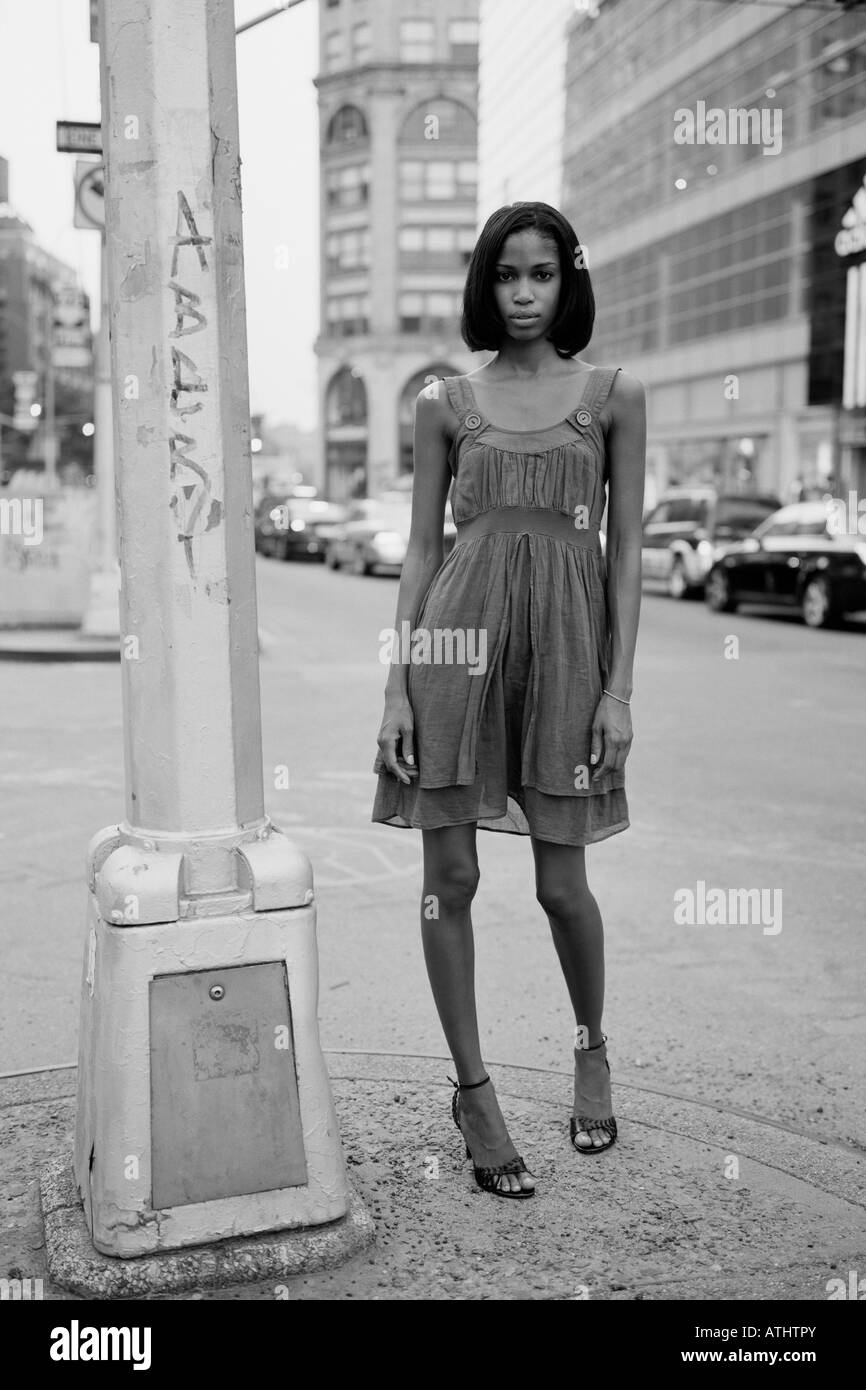 Young woman stands in the middle of Houston Street in New York City Stock Photo