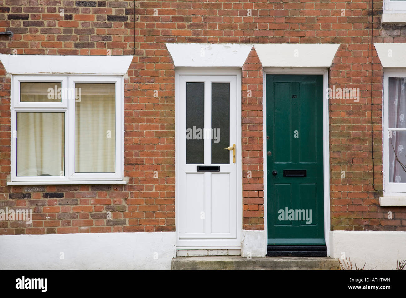Victorian terraced houses one with uPVC replacement windows showing lintels above the door and window, Haslemere, Surrey,England Stock Photo
