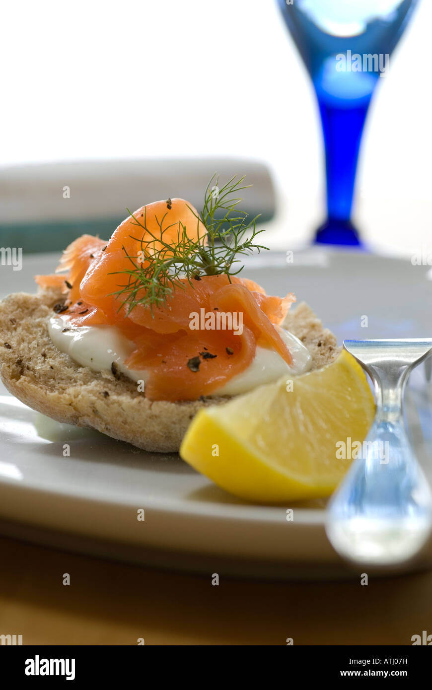 Smoked salmon sandwich with creme fraiche and lemon wedge Stock Photo