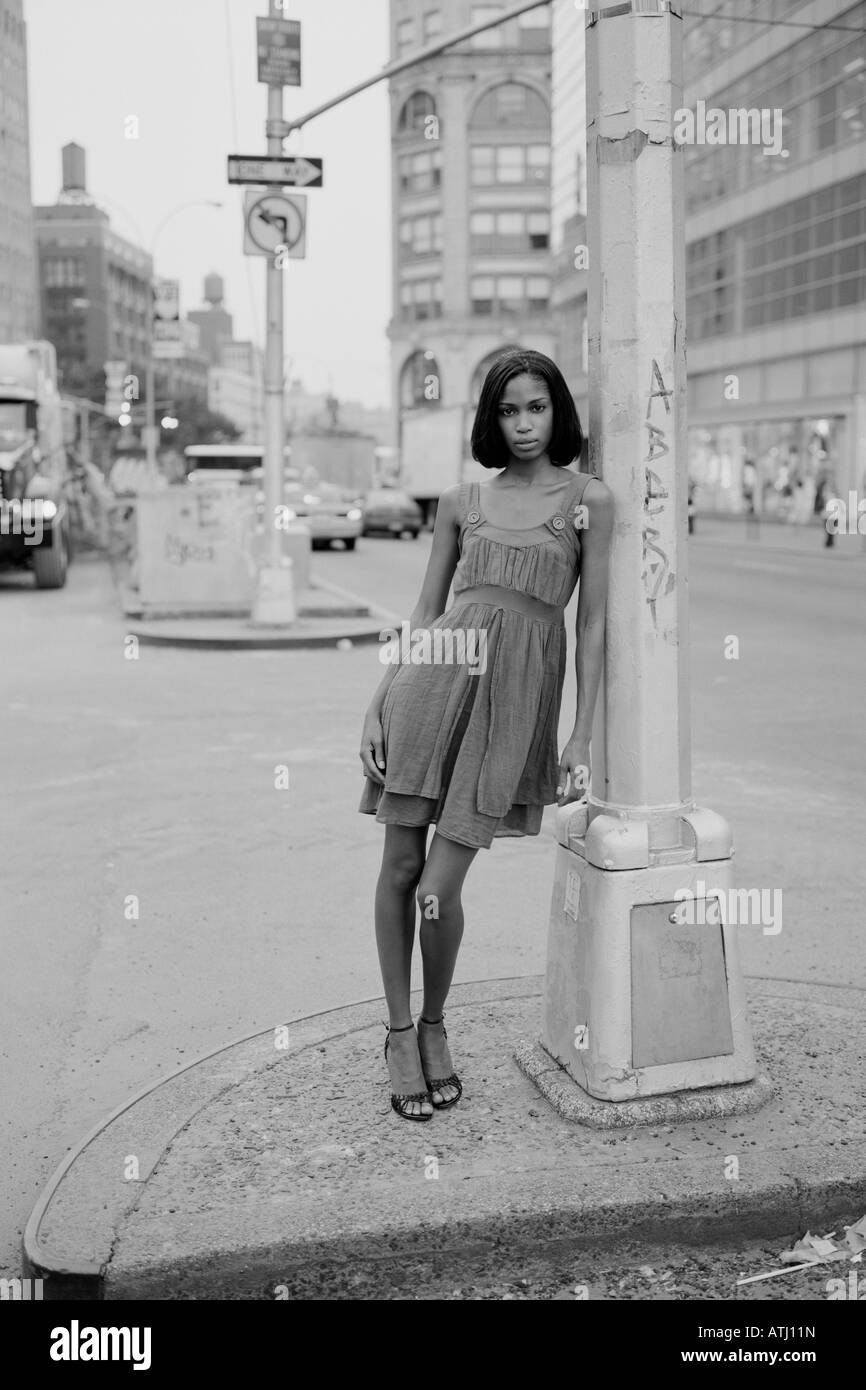 Young woman stands on a median on Houston Street New York City Stock Photo