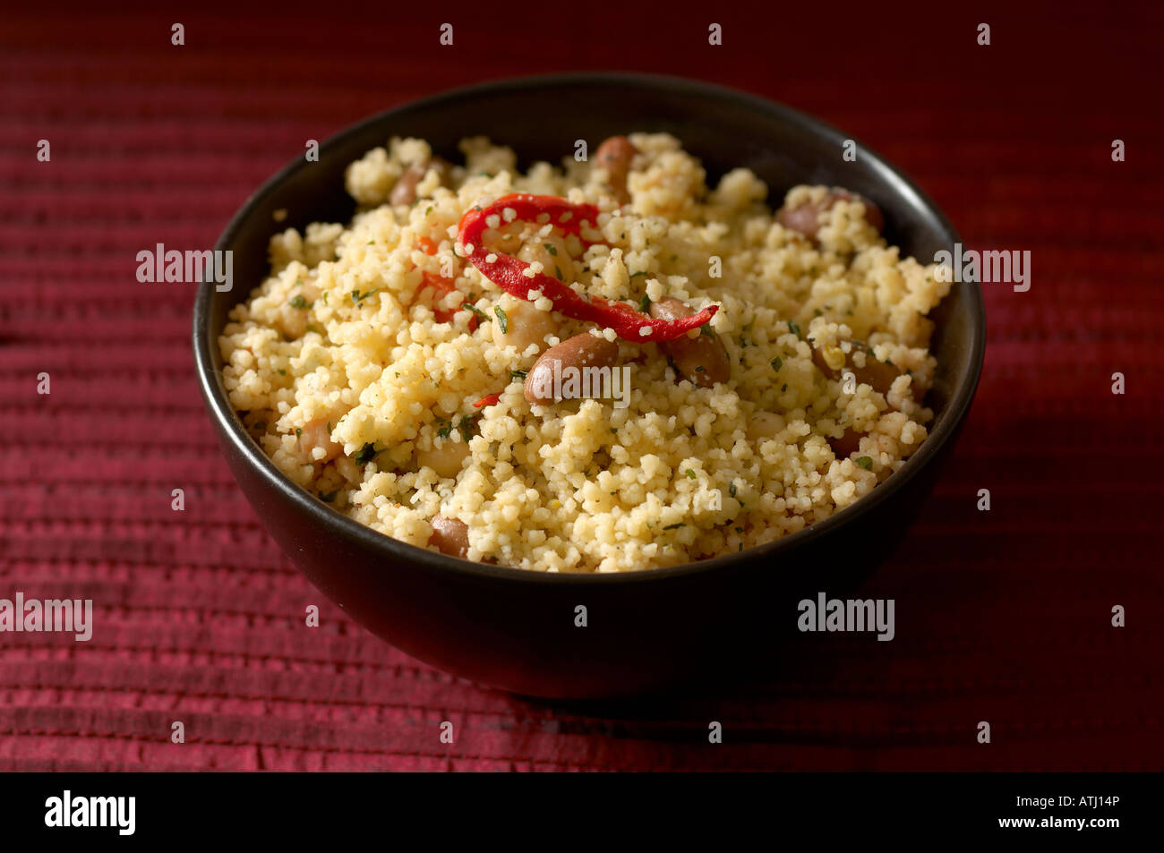 Cous Cous with roasted pepper borlotti beans chickpeas and parsley Stock Photo