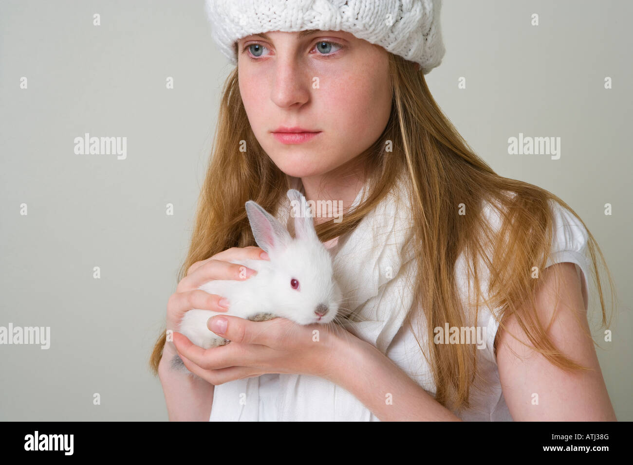 teenage girl holding white rabbit Stock Photo