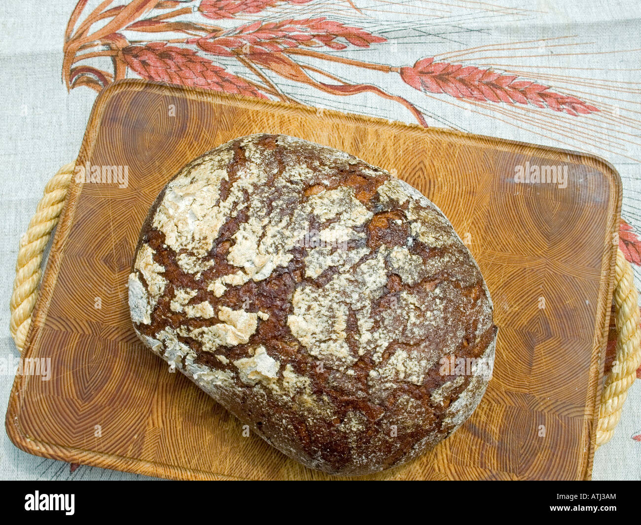 loaf of coarse rye bread on wooden board farmhouse bread Stock Photo