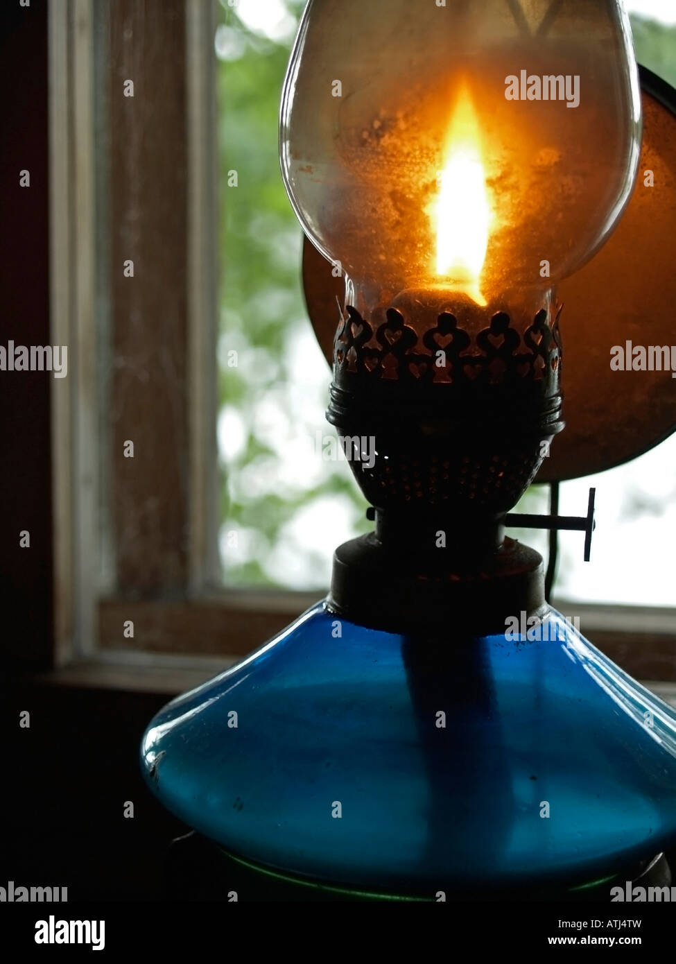 old oil lamp burning with bright flame at window Stock Photo - Alamy