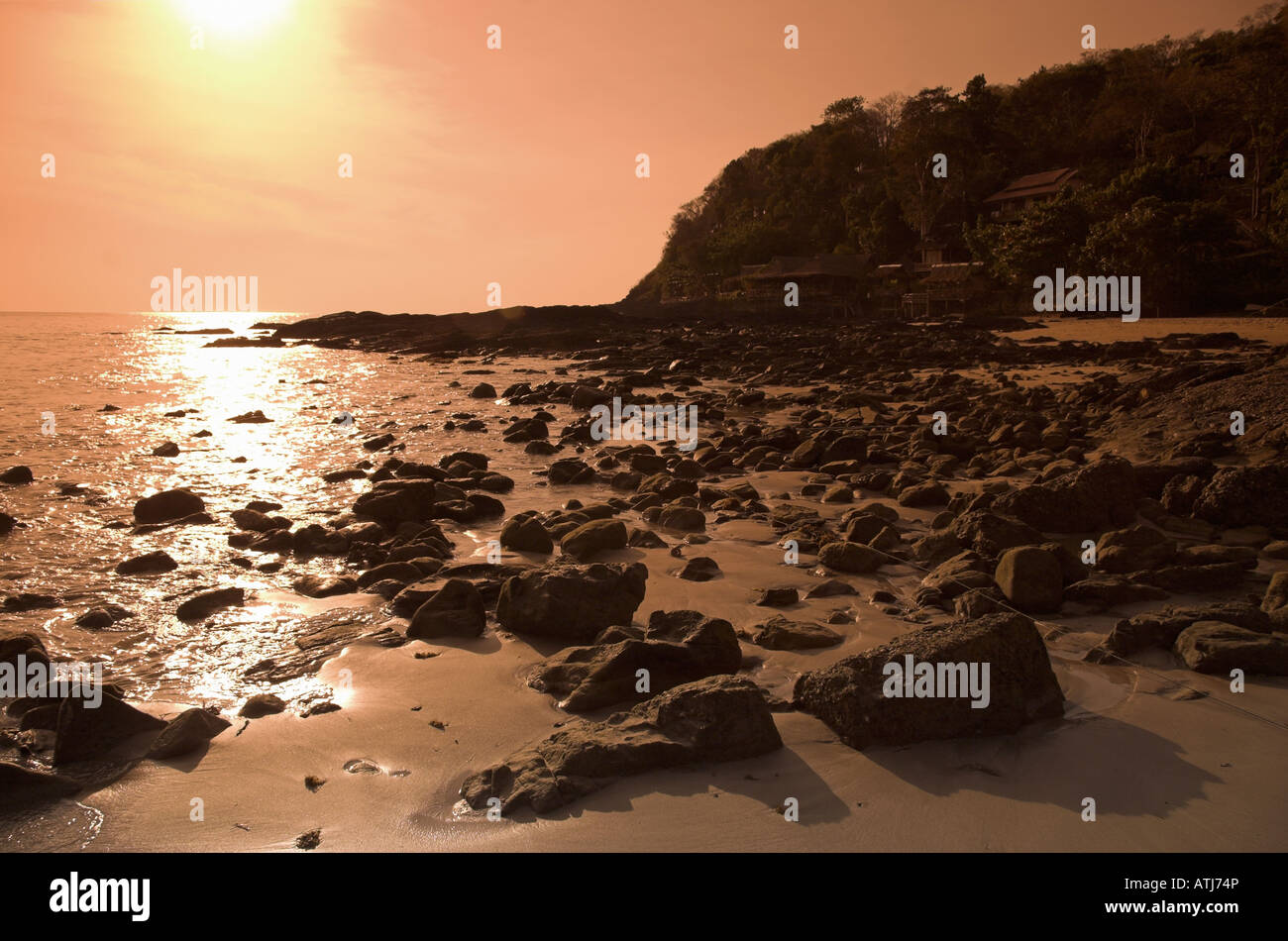Setting sun with rocks and shadows, Hat Mai Phai (Mai Phai Beach), Ko Lanta, Thailand Stock Photo