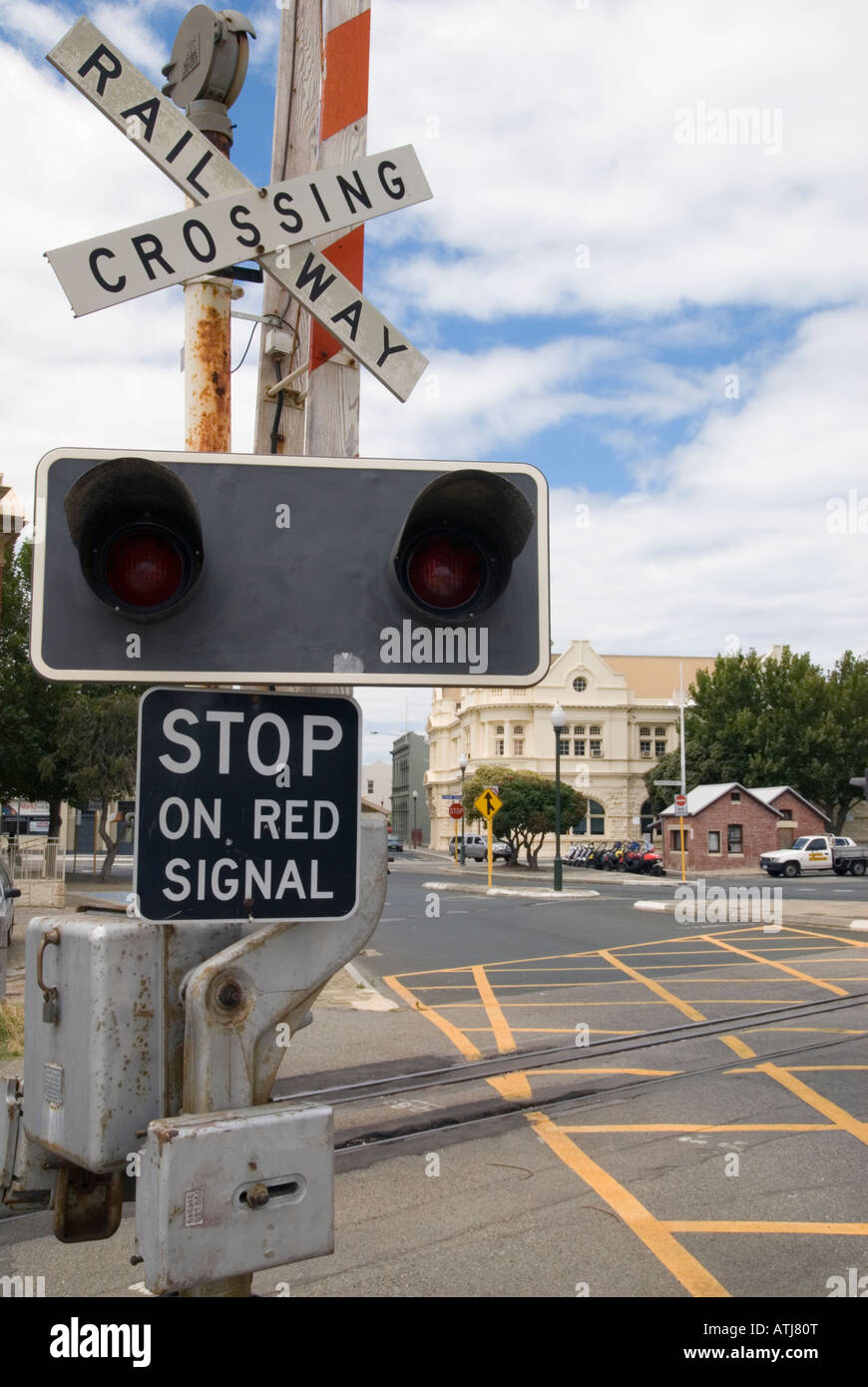 Safety signage railway crossing sign including lights, bell and boom gate at a level crossing in Fremantle, Western Australia Stock Photo