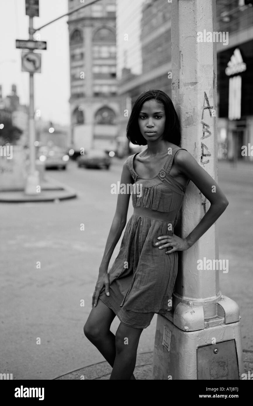 Young woman stands in the middle of Houston Street in New York City Stock Photo