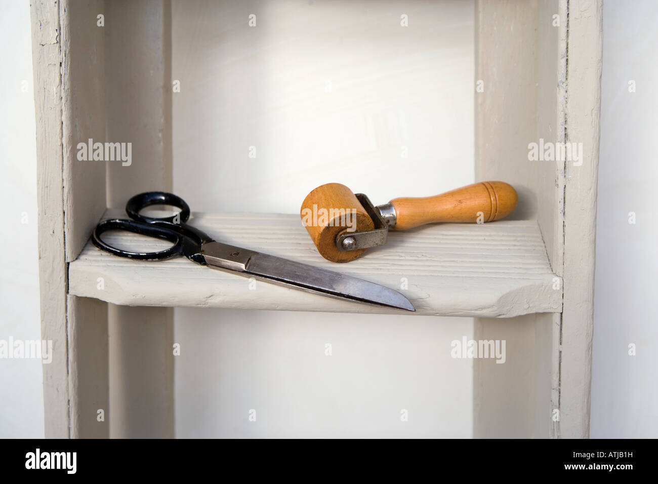 Retro style shot of stepladders with sissors and a wooden wallpaper