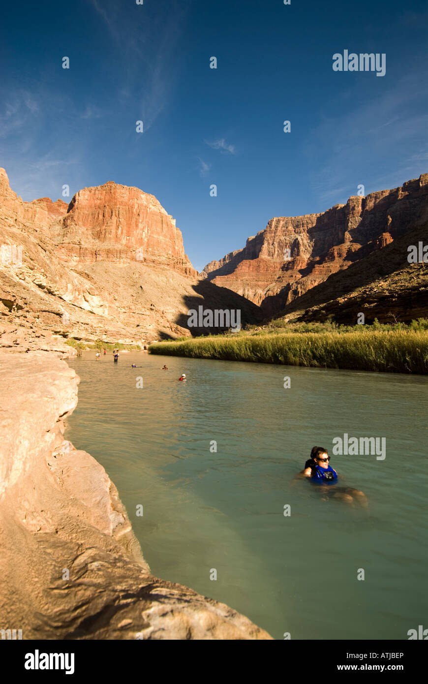 Man floating down the aqua blue water of the Little Colorado River, a tributary to the Colorado River, Grand Canyon, Arizona. Stock Photo