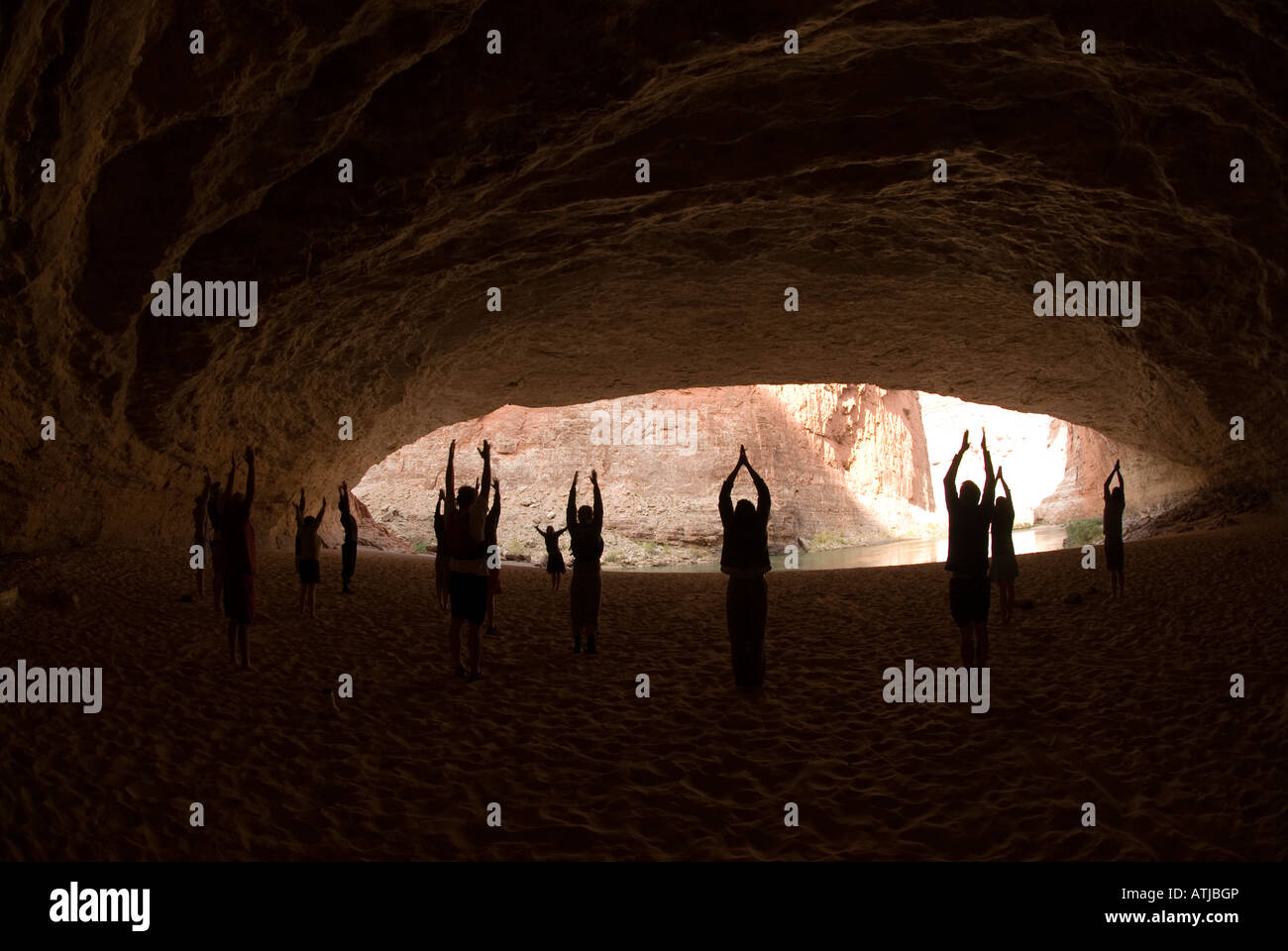 Group doing Yoga in Redwall Cavern on the Colorado River in the Grand Canyon National Park Arizona Stock Photo