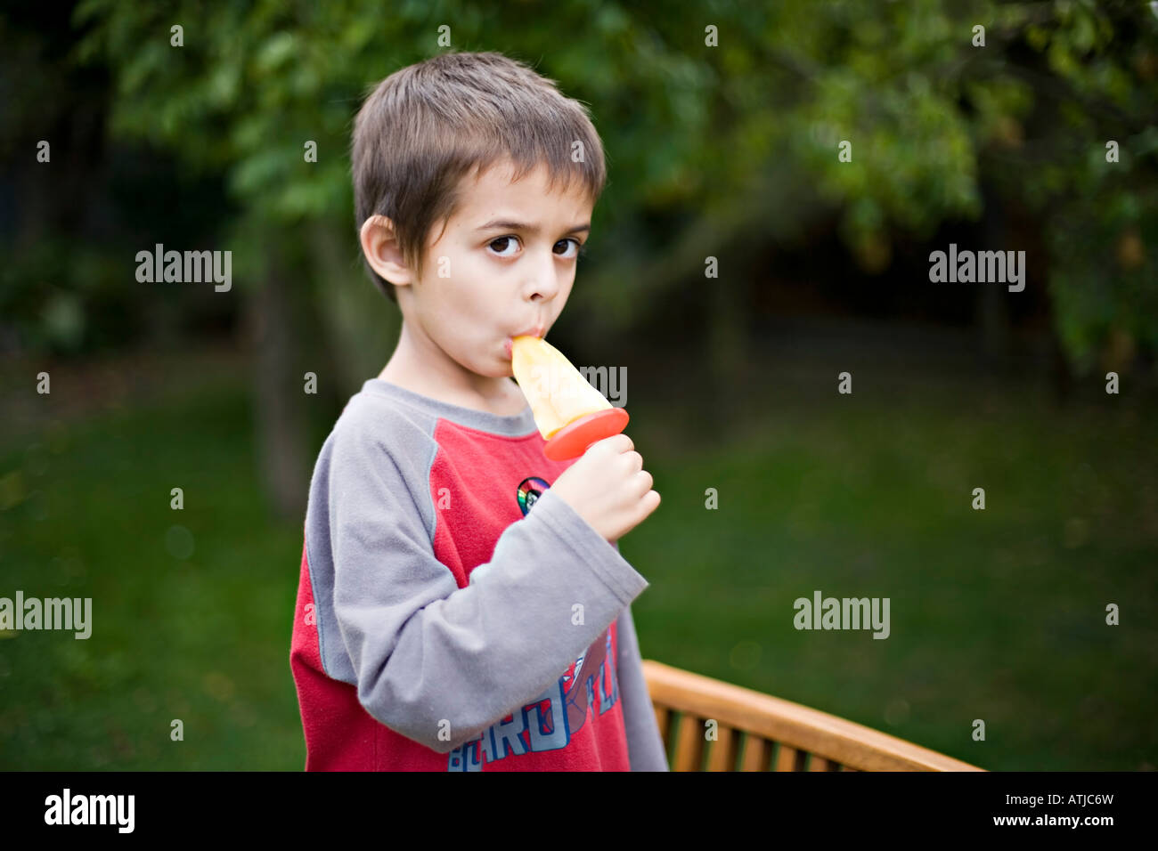 Little girl sucking lollipop hi-res stock photography and images - Alamy