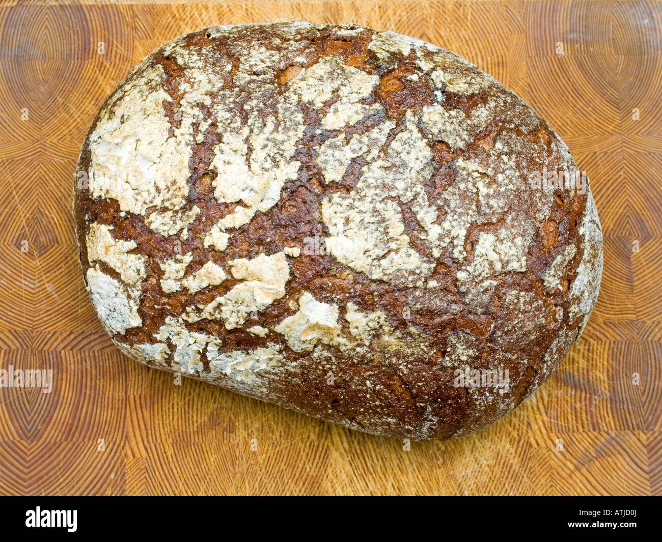 loaf of coarse rye bread on wooden board farmhouse bread Stock Photo