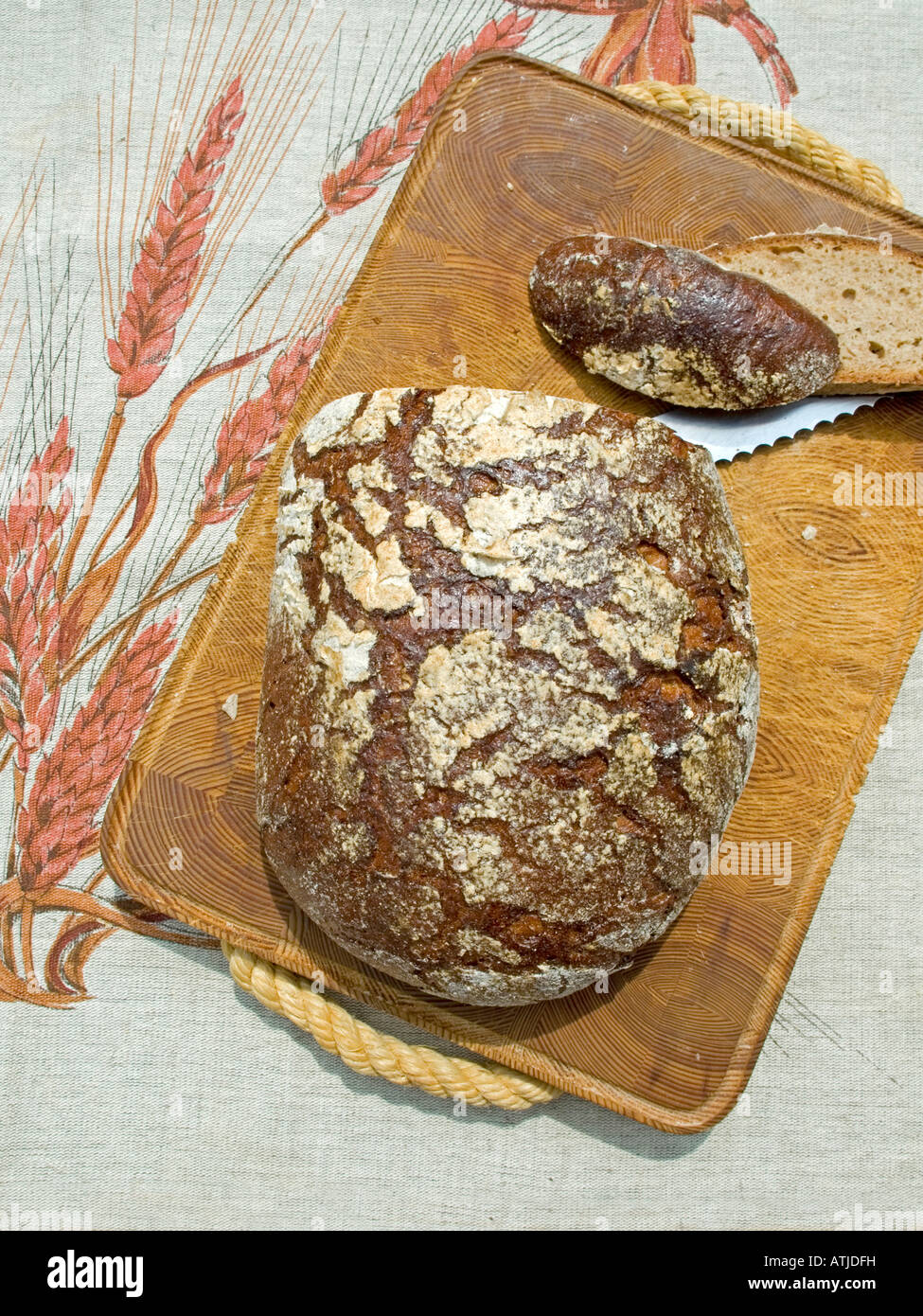 cutted loaf of coarse rye bread on wooden board farmhouse bread Stock Photo