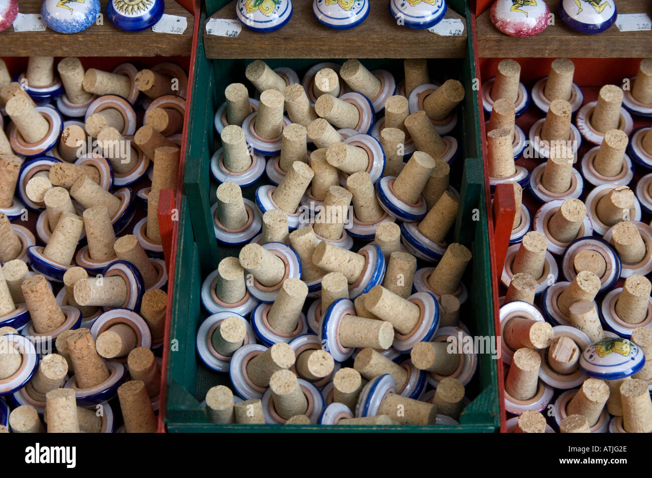 Boxes of colourful ceramic-topped bottle corks on sale in the popular Sicilian resort of Taormina, Italy Stock Photo