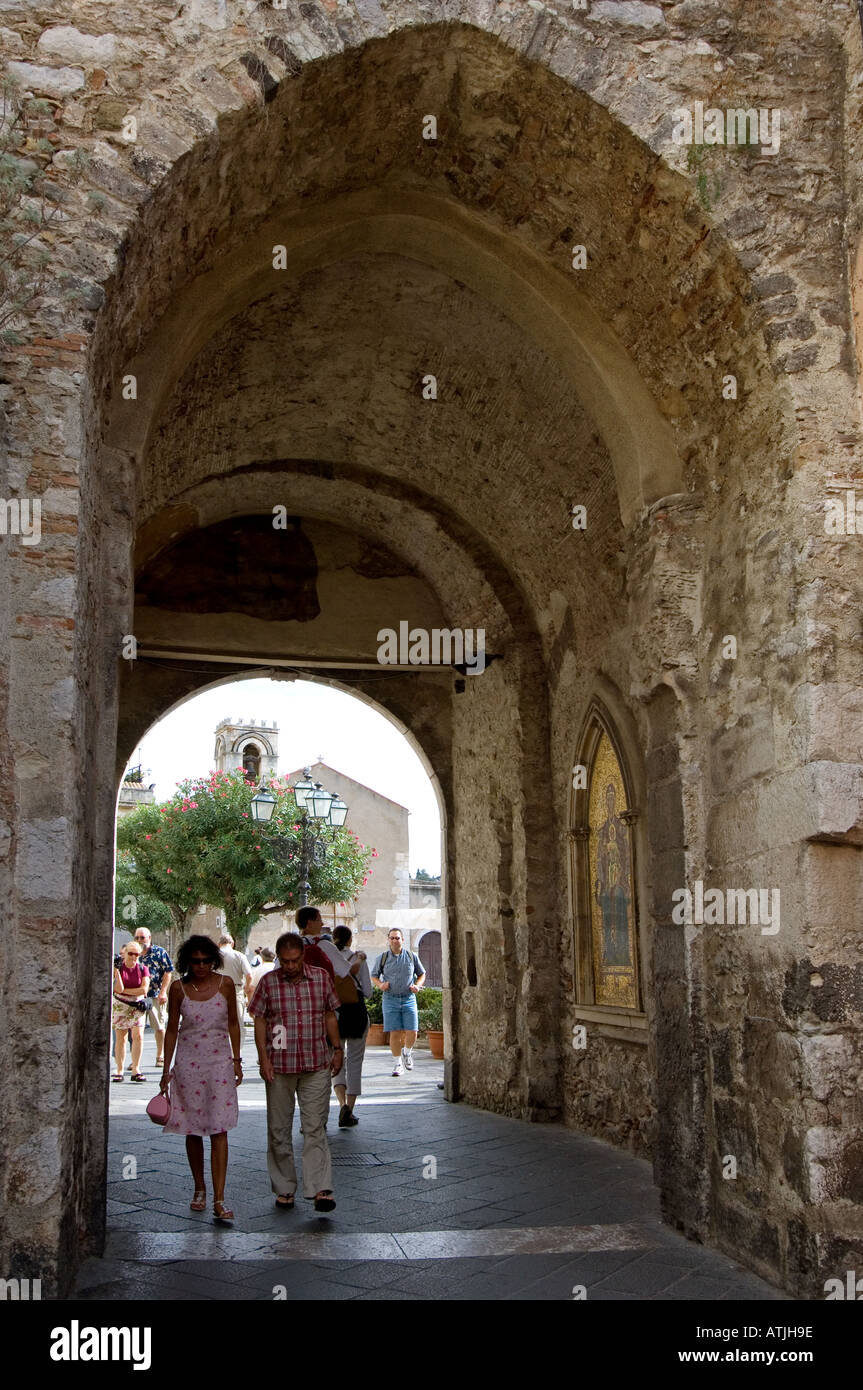 Passing under the Torre dell' Orologia on the Corso Umberto 1, the main street of the resort of Taormina, Sicily, Italy Stock Photo
