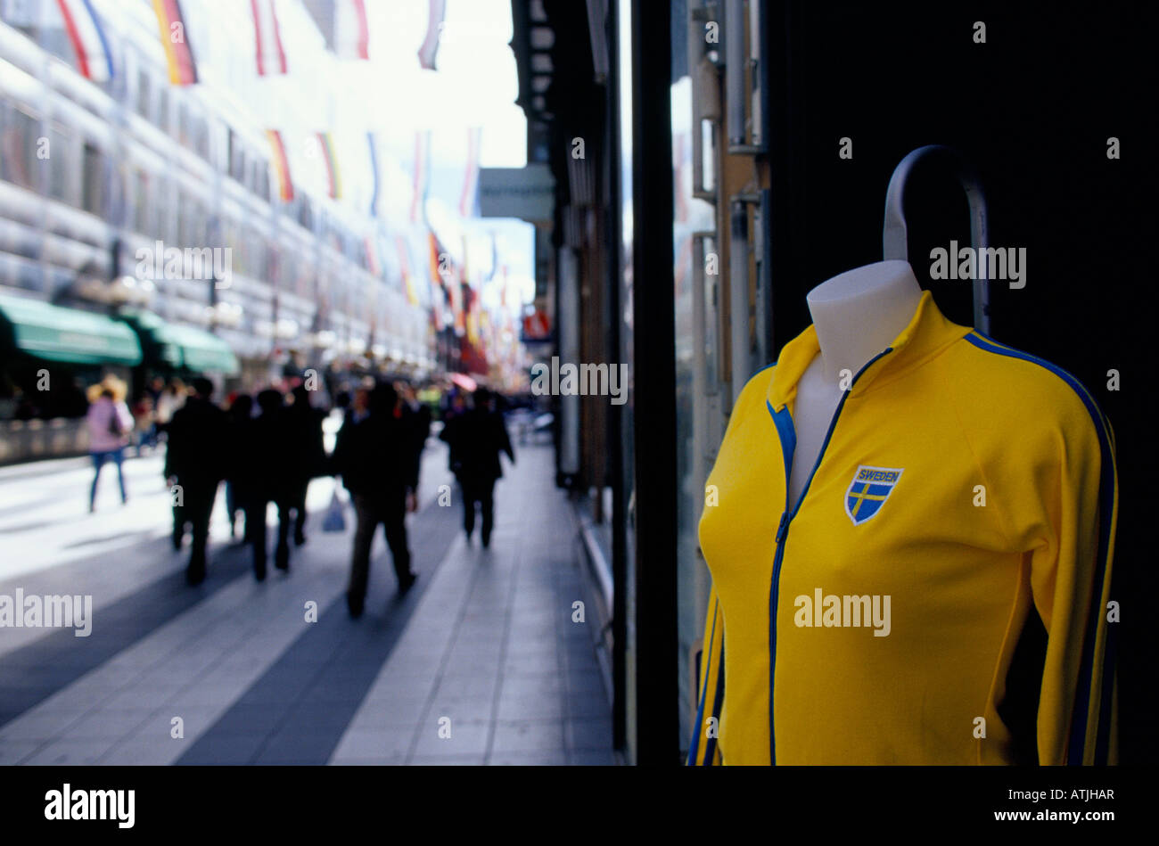 Yellow zip up sports top with Swedish flag badge on dummy outside a shop on the main shopping street Drottninggatan in Stockholm Stock Photo