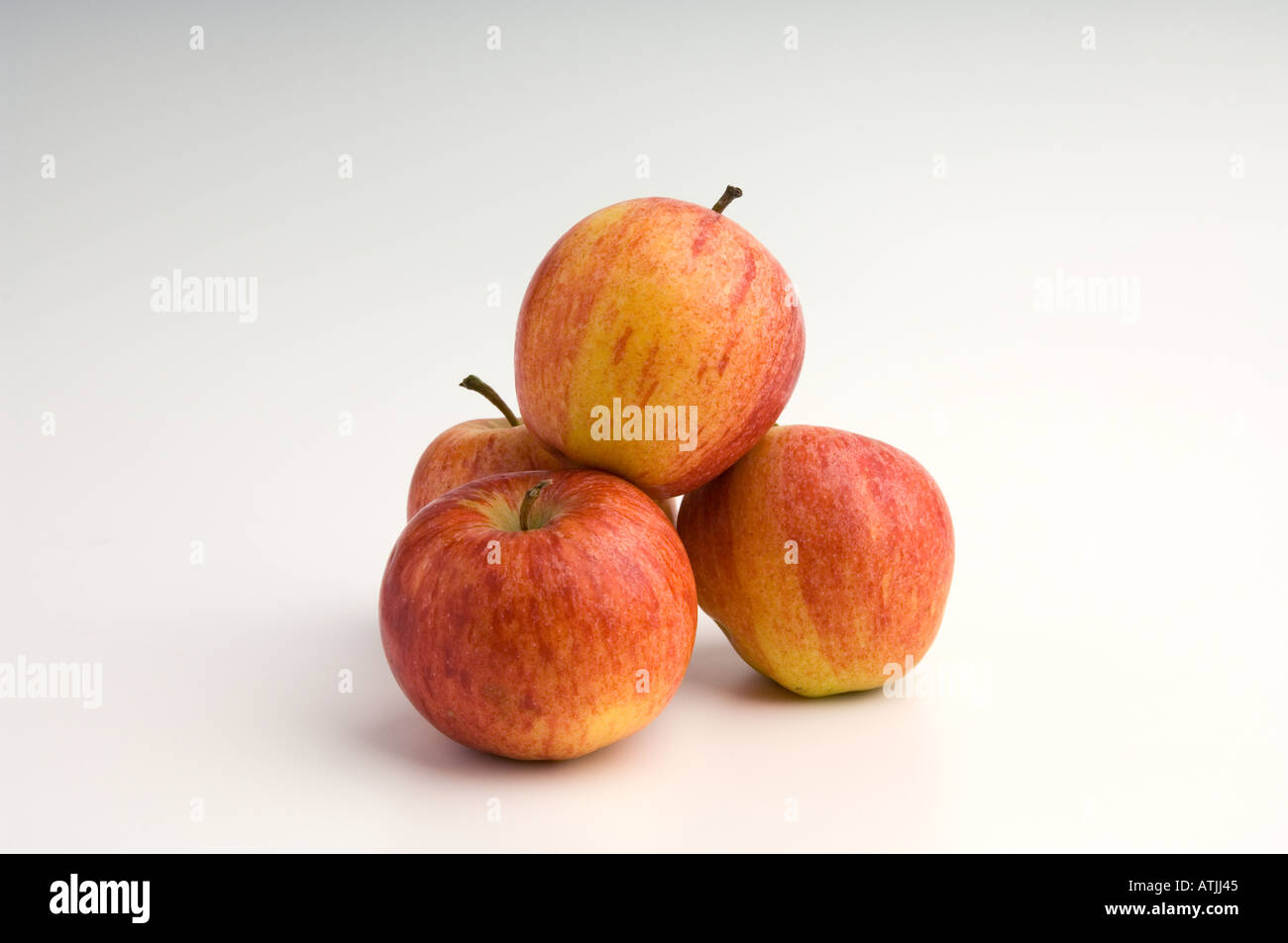 A mound of four Gala apples on a white background Stock Photo