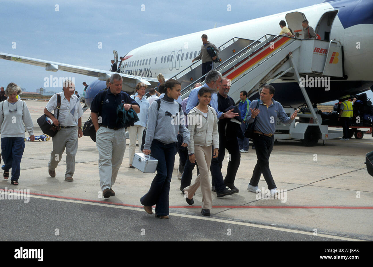 2 teenage girls disembarking aeroplane at Murcia airport with other passengers Stock Photo