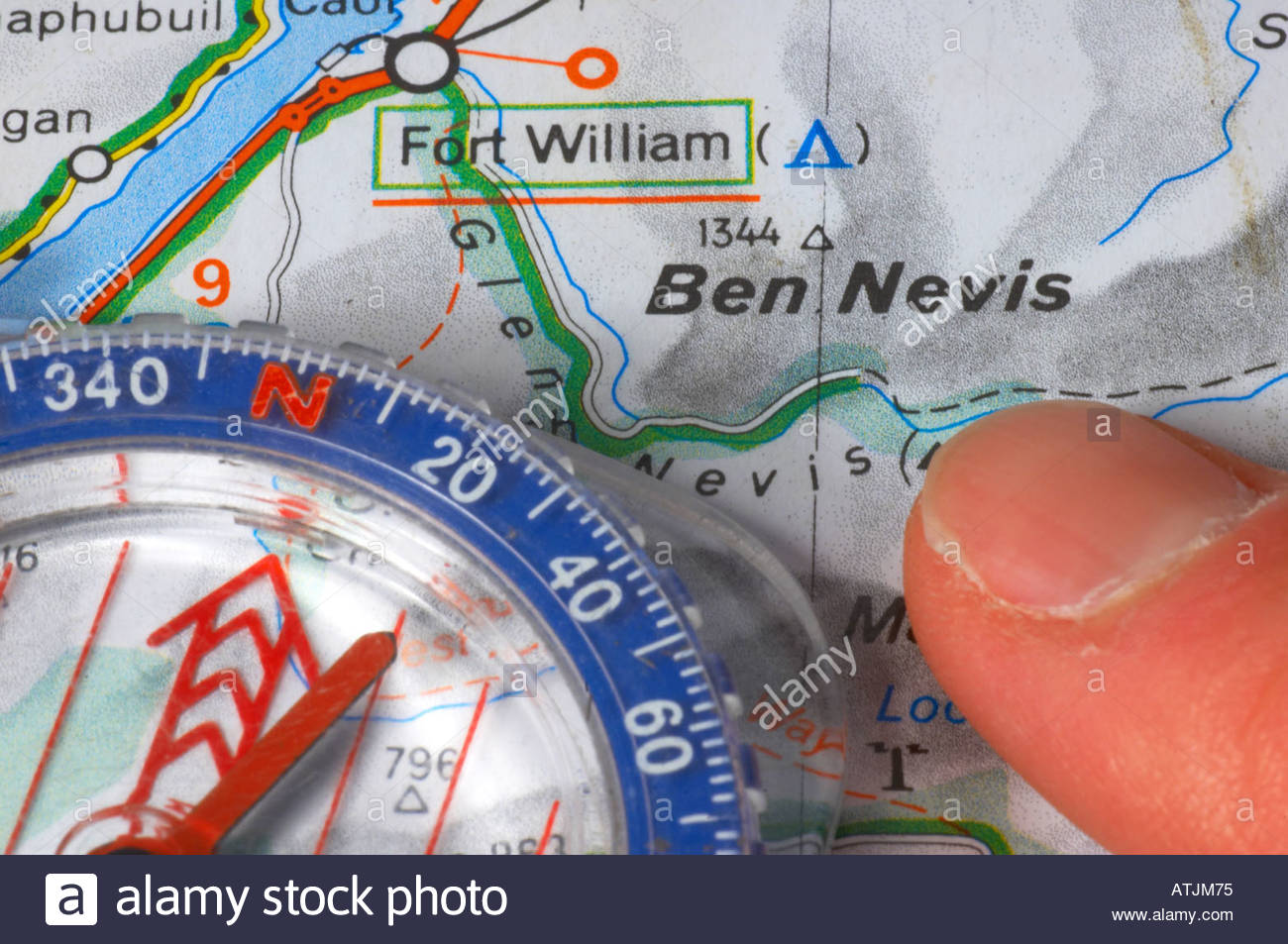 Someone pointing at a map of Ben Nevis and a compass Stock Photo