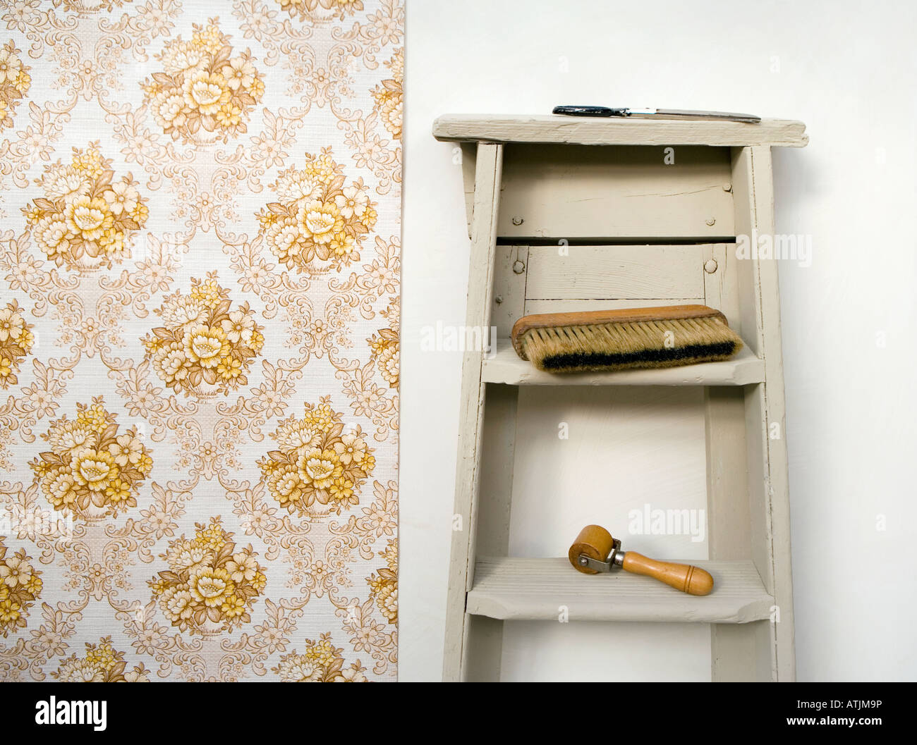 Retro style shot of handing wallpaper. VIntage wallpaper, stepladders and wallpaper brush.s Stock Photo