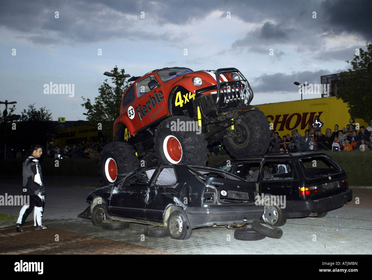 Stuntshow Monstertruck and Stuntshow, a monstertruck is driving over two old cars ...