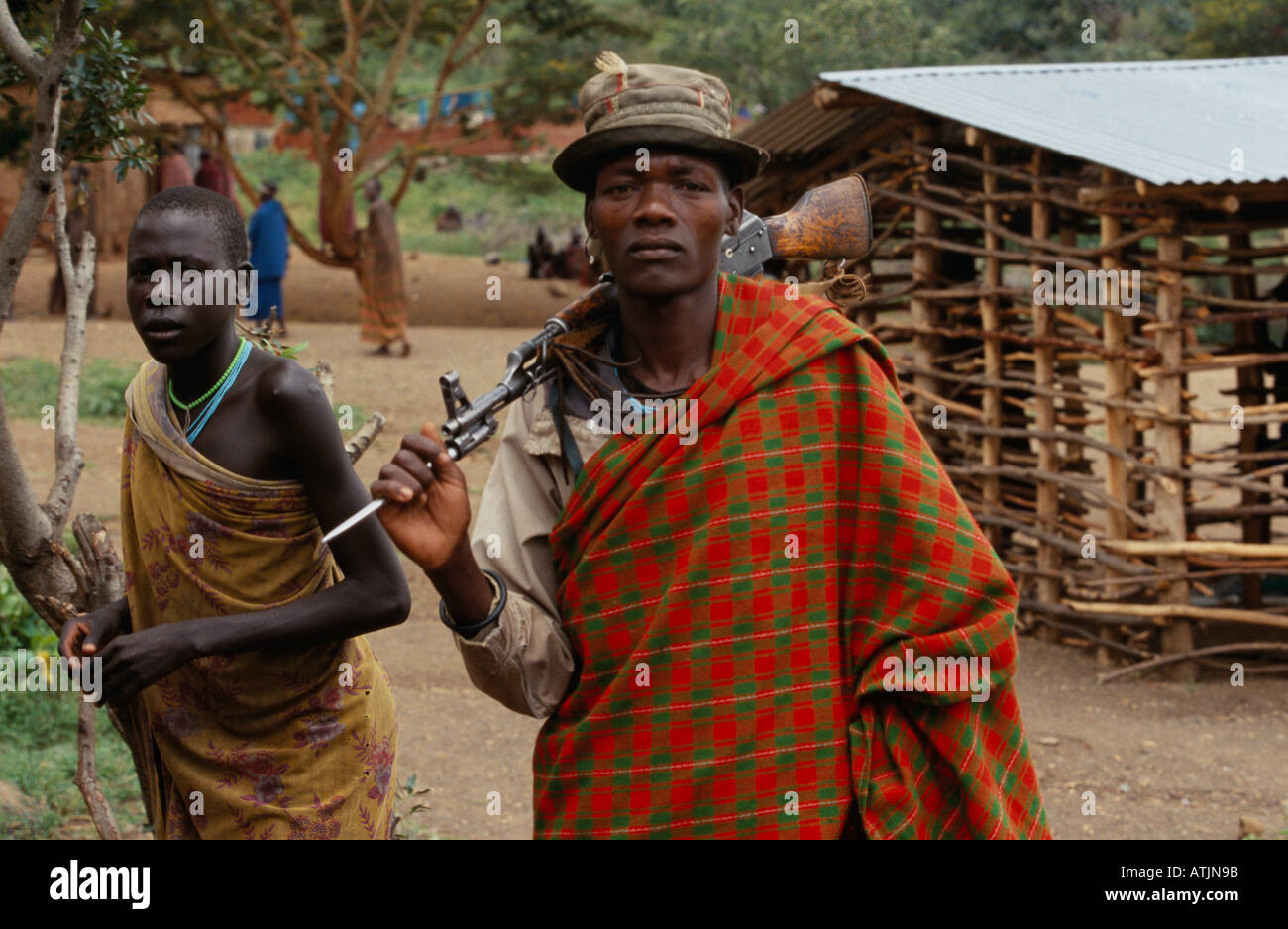 Karamoja cattle herder with rifle in village, Uganda Stock Photo