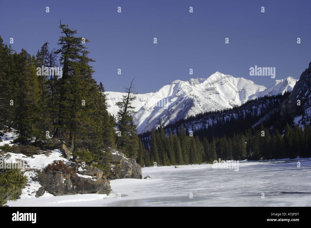 Rockies and frozen Bow river near Banff village, Alberta Stock Photo
