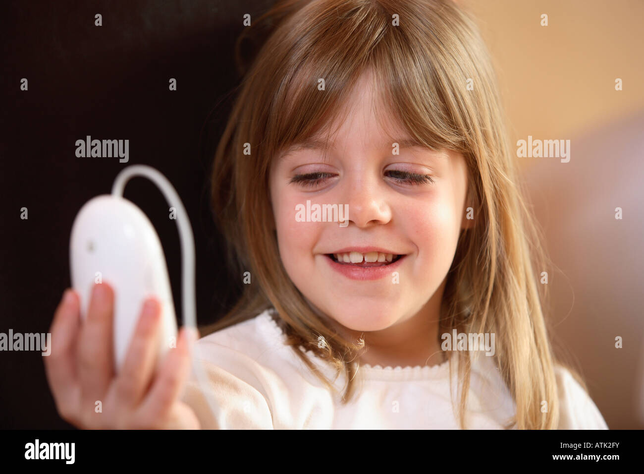 Child holding up computer mouse Stock Photo