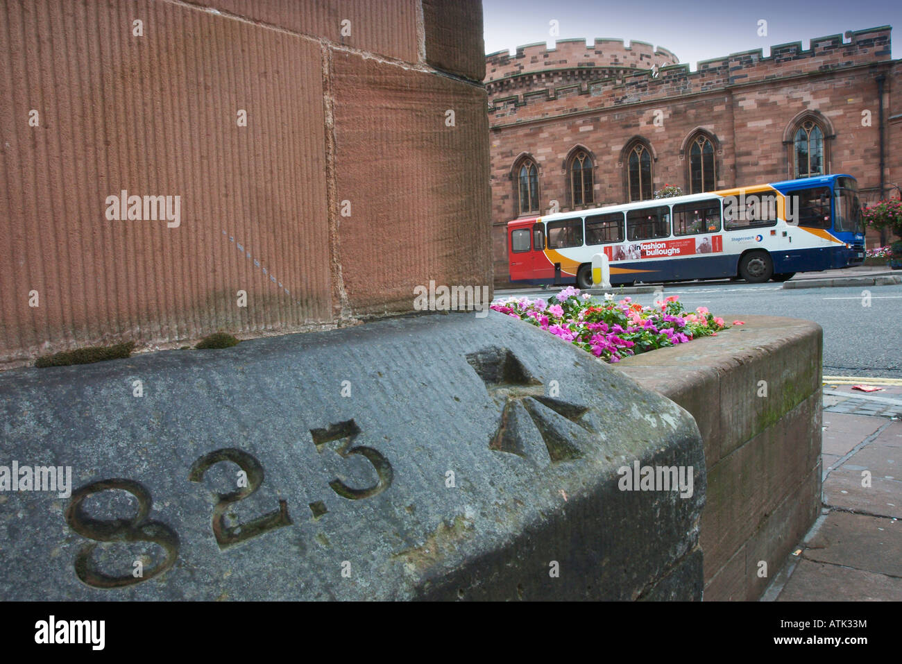 Public bus outside Carlisle County Council Offices with benchmark in foreground Stock Photo