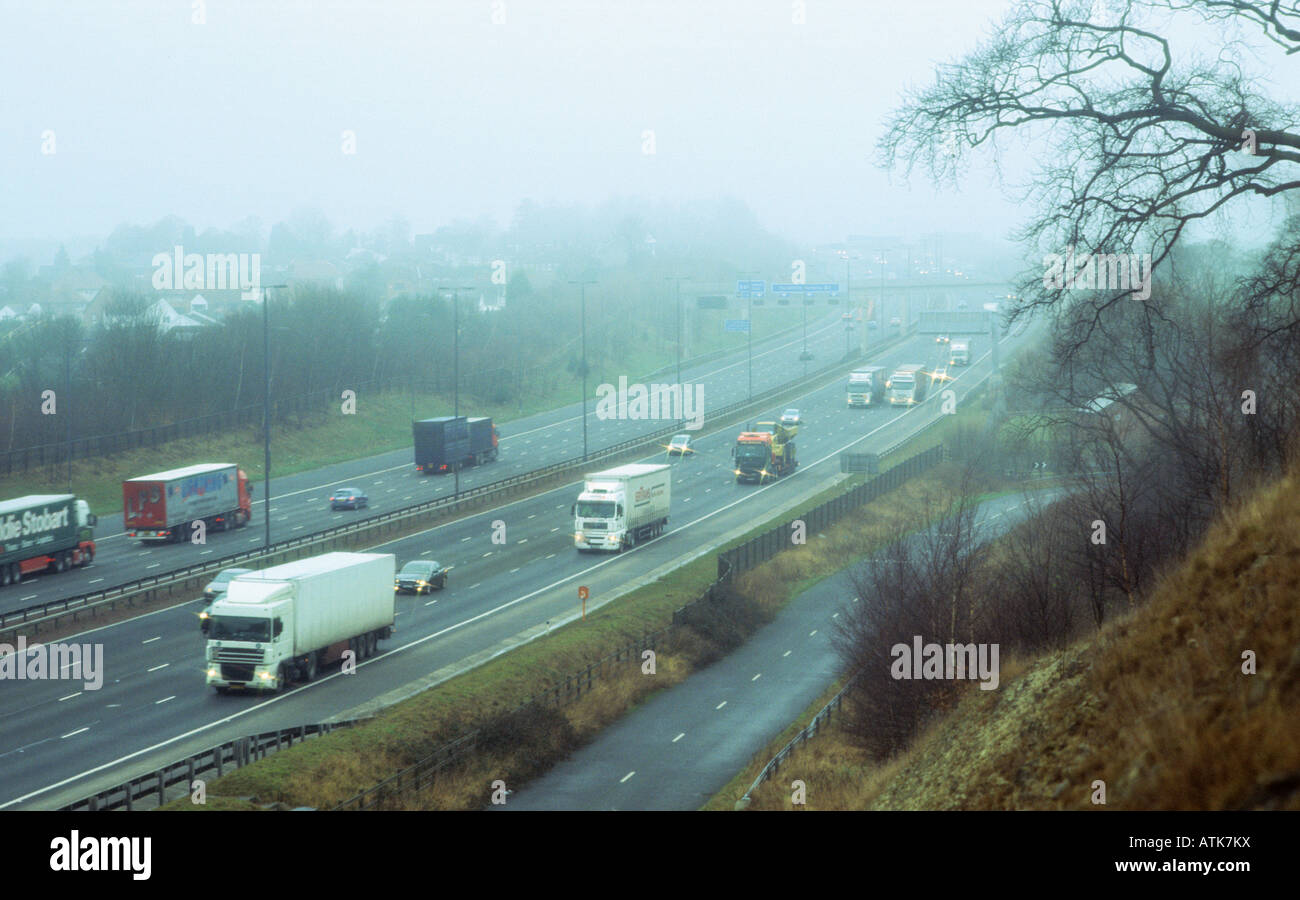 traffic travelling on the A1 M1 motorway in thick fog near the village of Aberford Leeds Yorkshire UK Stock Photo