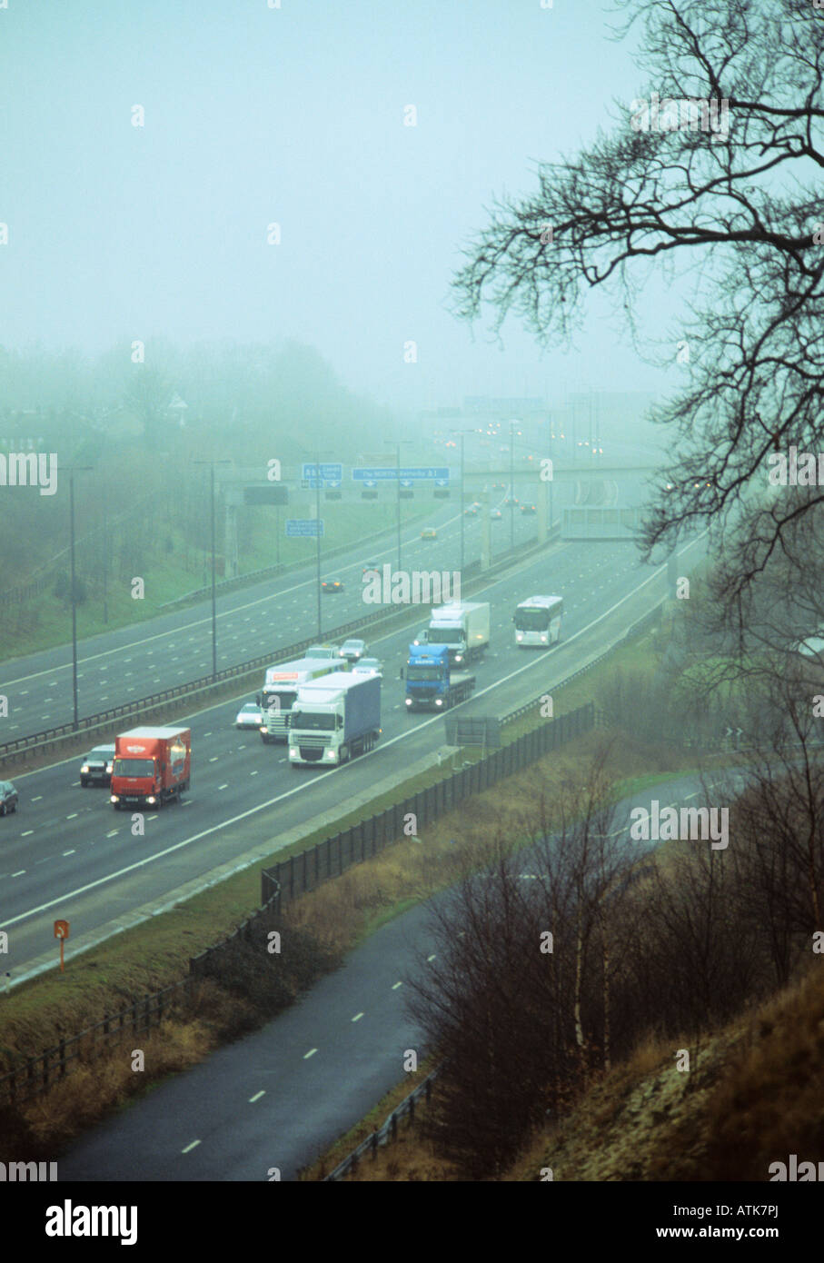 traffic travelling through thick fog on the A1 M1 motorway Leeds Yorkshire UK Stock Photo