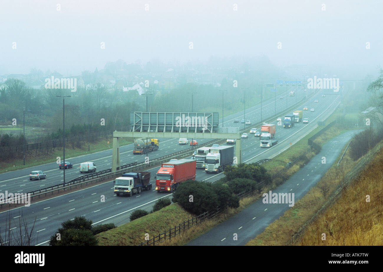 traffic travelling through thick fog on the A1 M1 motorway Leeds Yorkshire UK Stock Photo