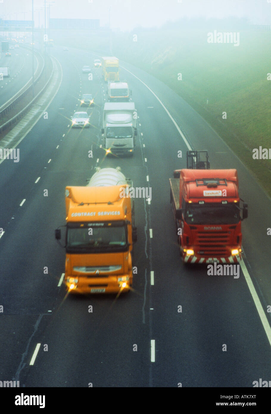 lorrys travelling through thick fog on the A1 M1 motorway Leeds Yorkshire UK Stock Photo