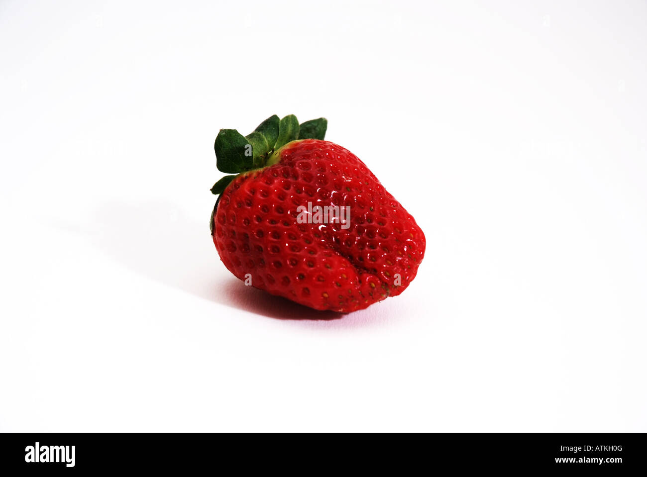 A single red Strawberry Eine einzelne rote Erdbeere Freisteller Stock Photo