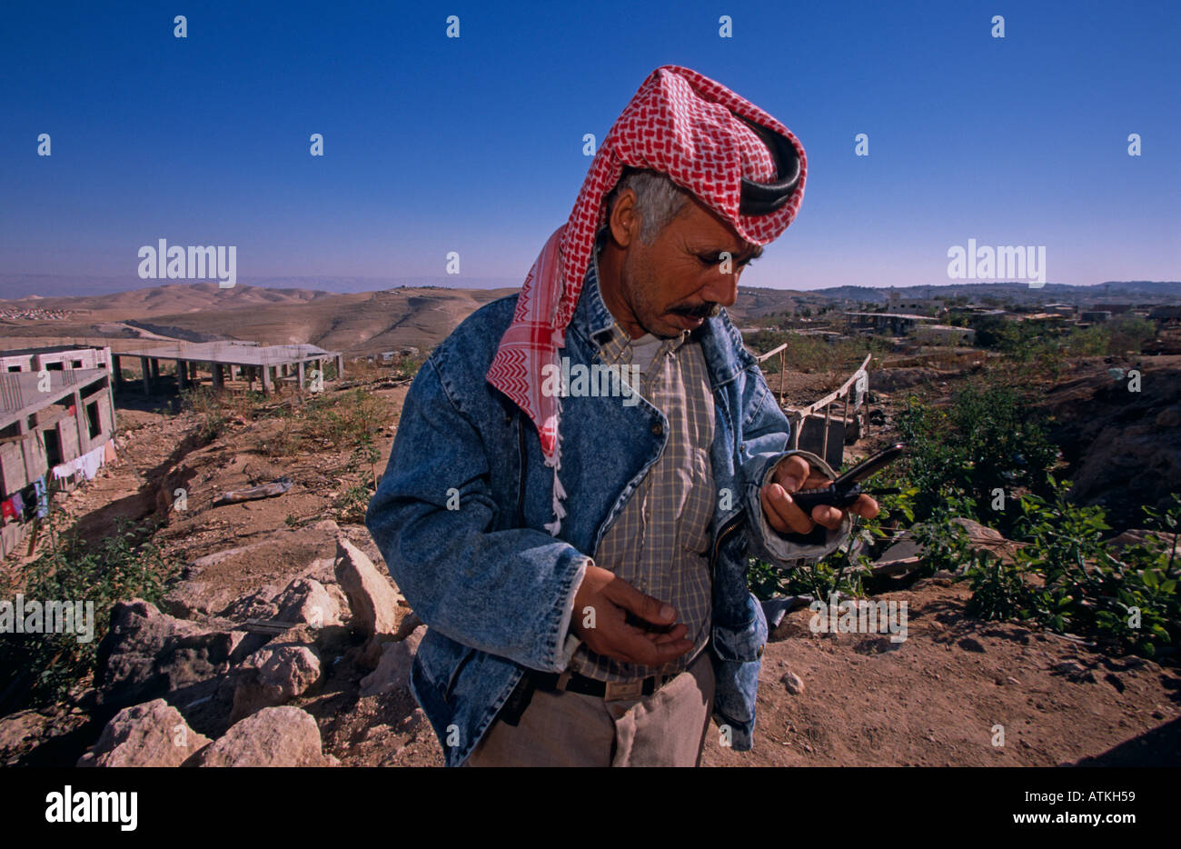 A Bedouin man using a cell phone Stock Photo
