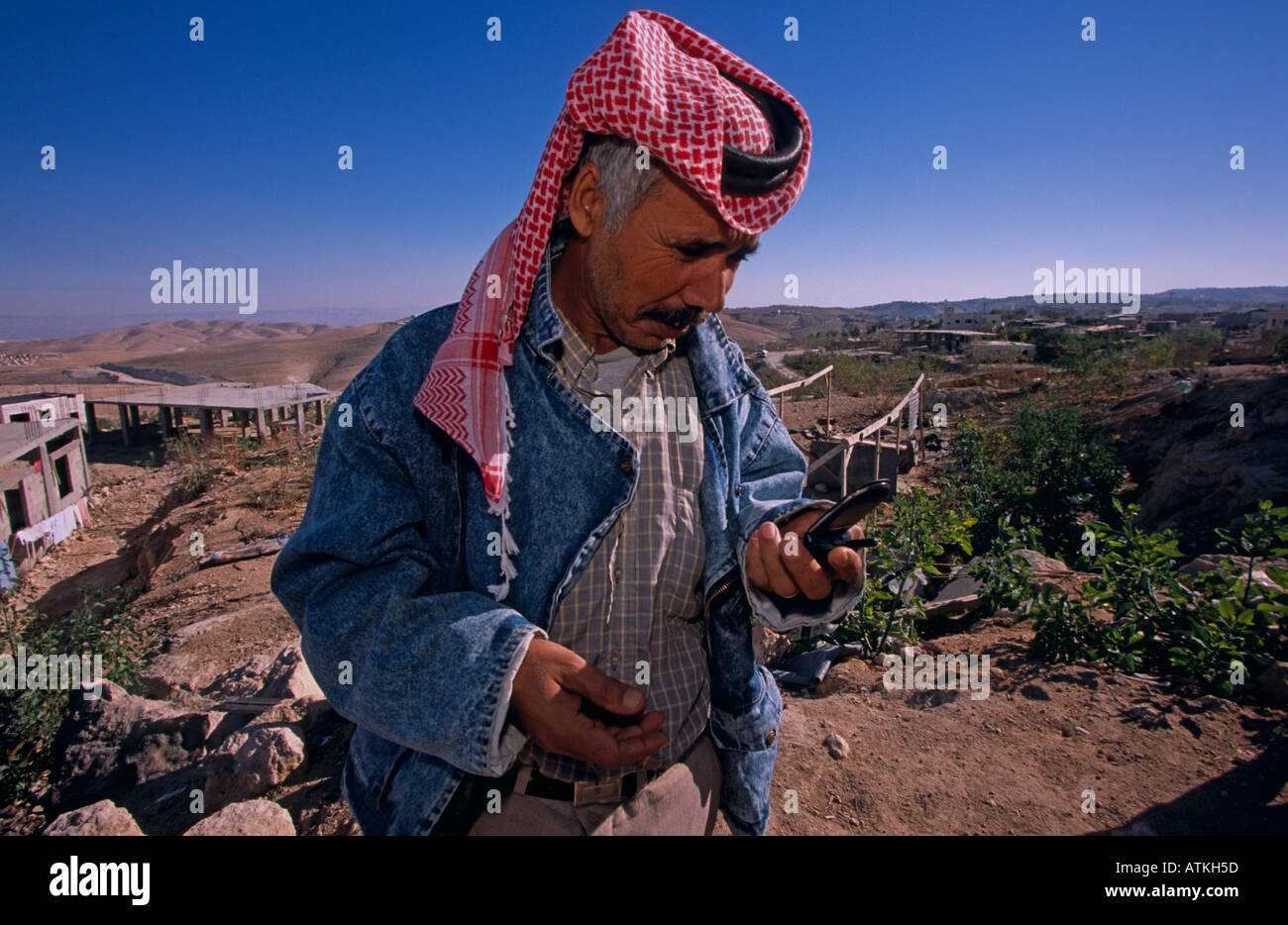 A Bedouin man using a cell phone Stock Photo