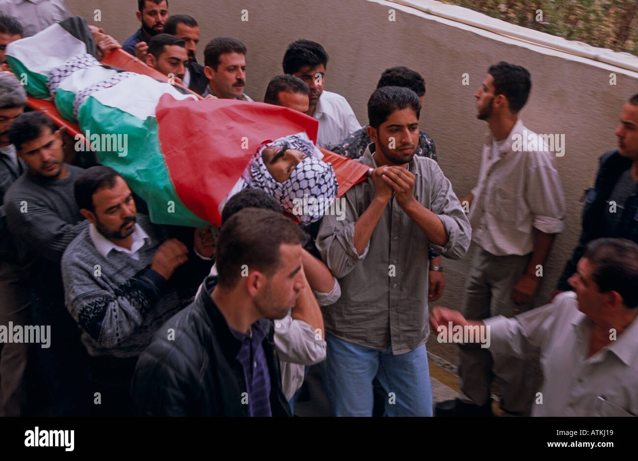 People carrying a body of a man wrapped in Palestine Flag Stock Photo