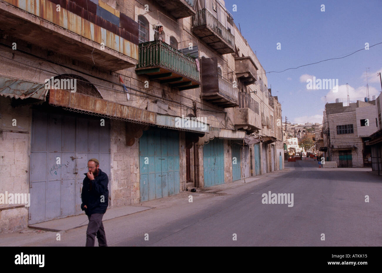 Jewish settler walking on deserted street. Palestinian part of Hebron. Stock Photo