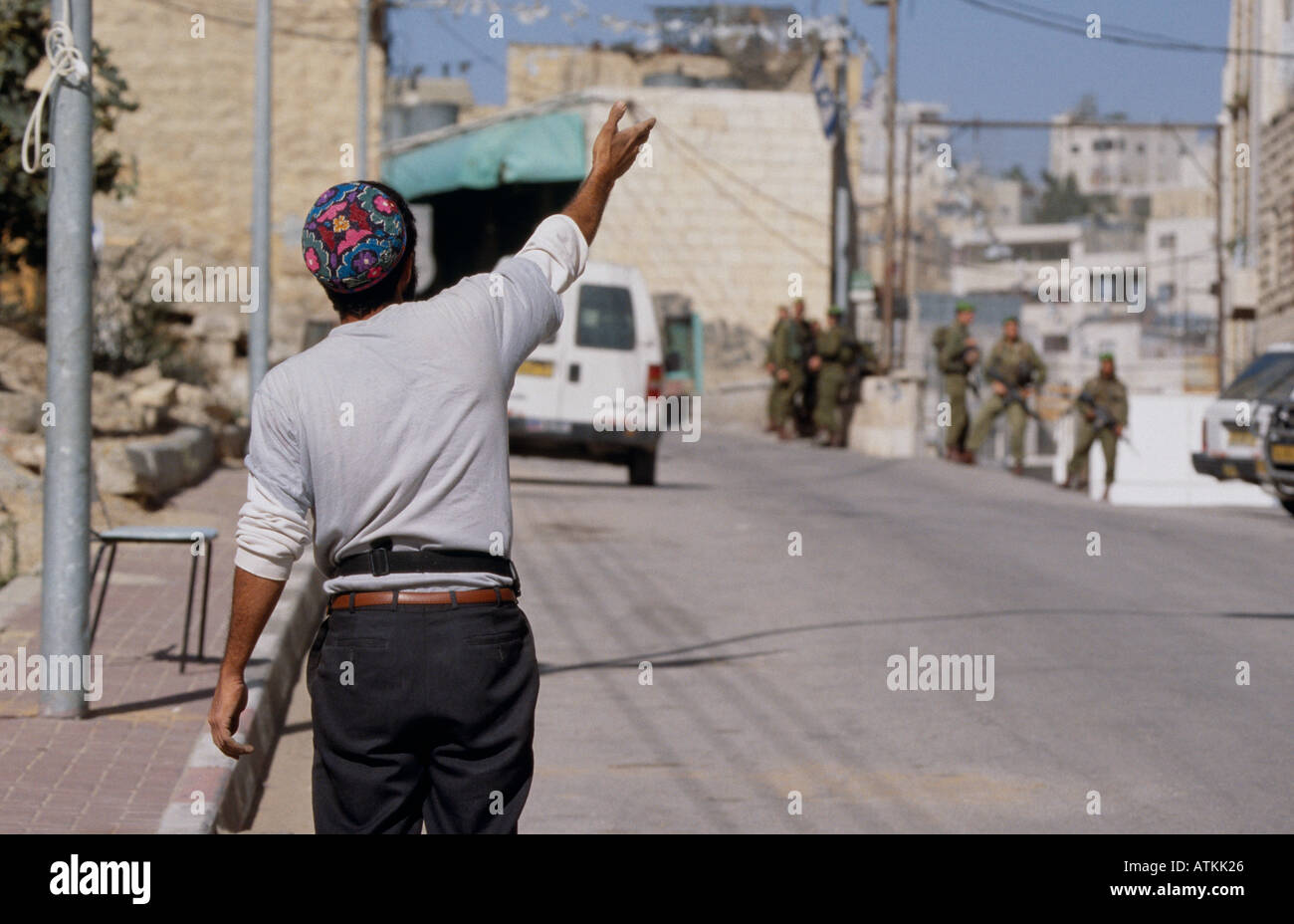 Jewish settler gesturing at soldiers, Hebron, West Bank, Jerusalem Stock Photo