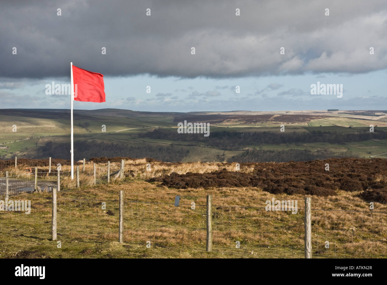 Red flag flying on the edge of Army training land in Swaledale, Yorkshire. Stock Photo