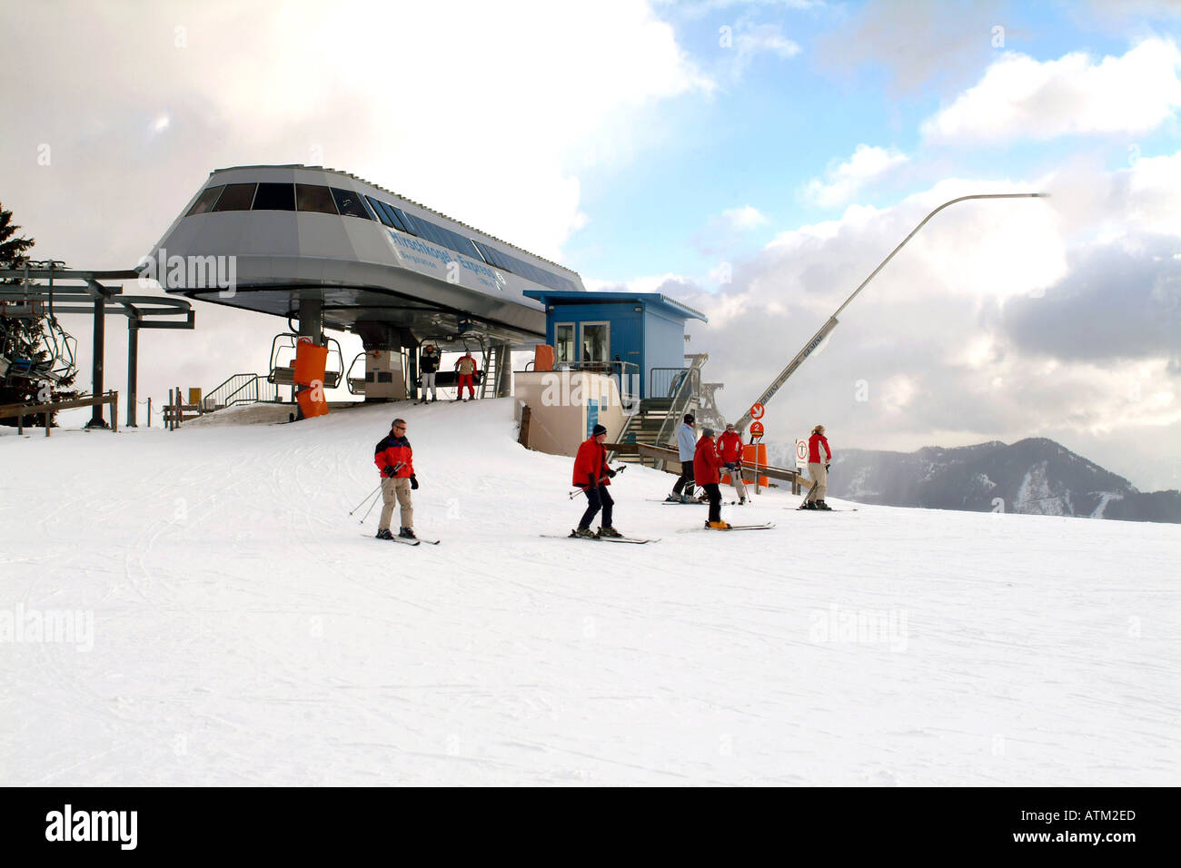 Chair lift and snow making machines on the Schmittenhohe mountain above Zell am See  Stock Photo