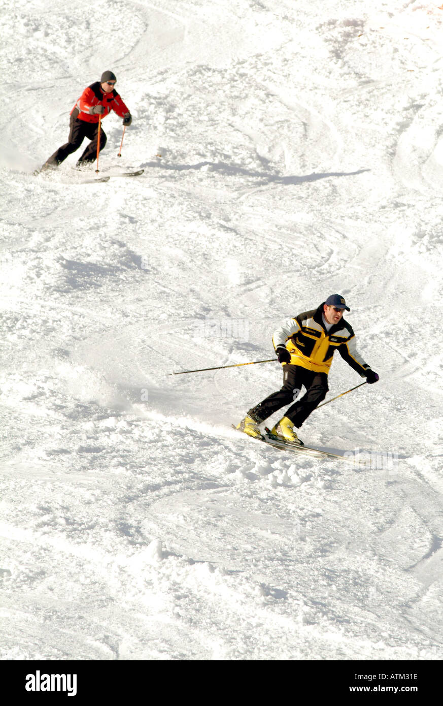 Skiers snowboarders skiing snowboarding on the pistes of the Schmittenhohe mountain above Zell am See  Stock Photo