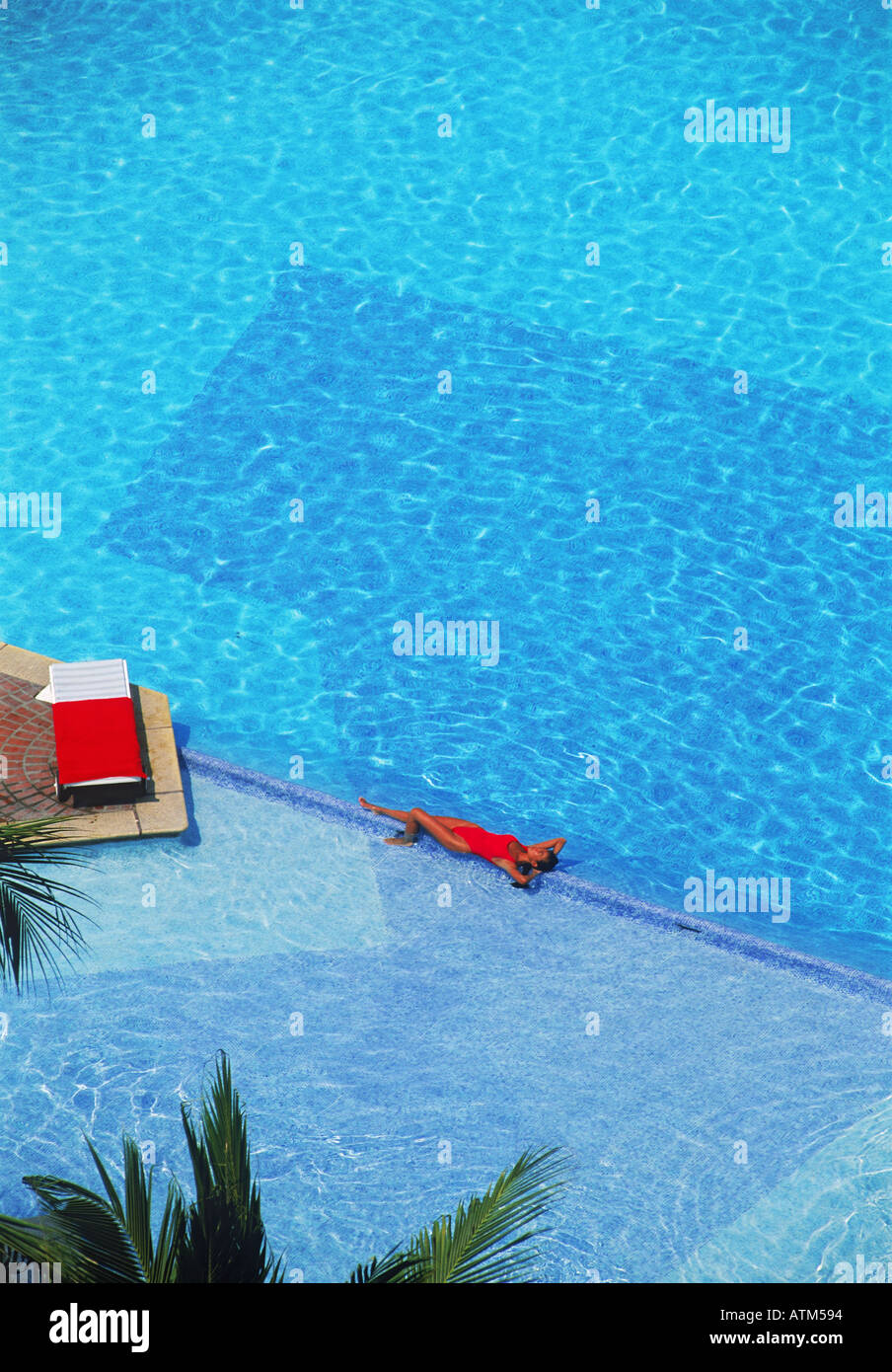 Woman in red bathing suit at swimming pool in Puerto Vallarta Mexico
