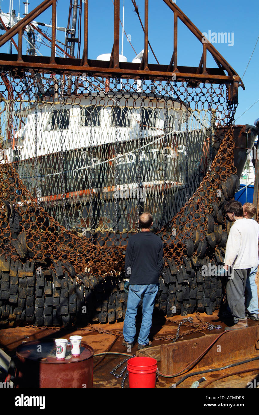 Fishing industry. Greenport Harbour. Long Island New York USA. Metal nets being repaired Stock